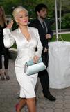 Christina Aguilera in white body-hugging dress arrives at Christian Dior Cruise 2009 Collection